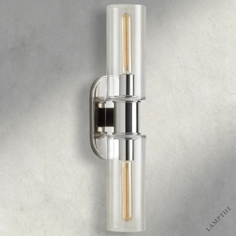 Lampthe Harlin double wall sconce with clear glass shades and polished nickel finish. Modern sophistication.