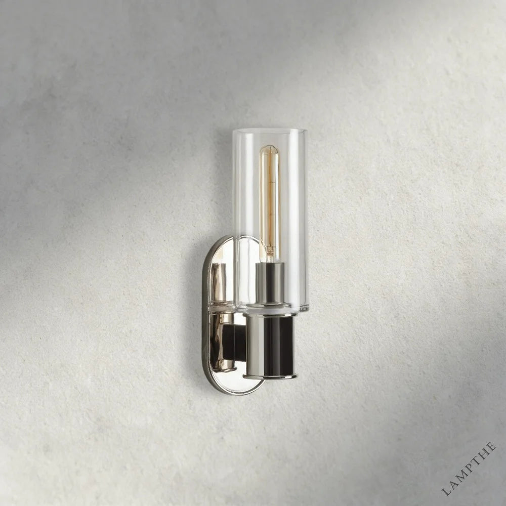Lampthe Harlin Sconce with clear glass shade and polished nickel finish, featuring a modern oval backplate.