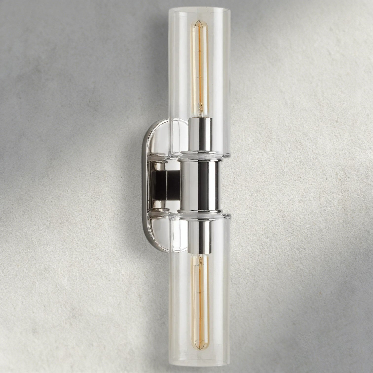 Lampthe Harlin double wall sconce with clear glass shades and polished nickel finish. Modern sophistication.