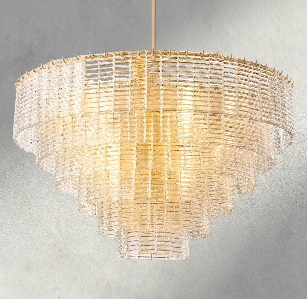 Lampthe Sirene clear glass round chandelier with textured cast glass cascading in concentric rings, emitting warm refracted light.