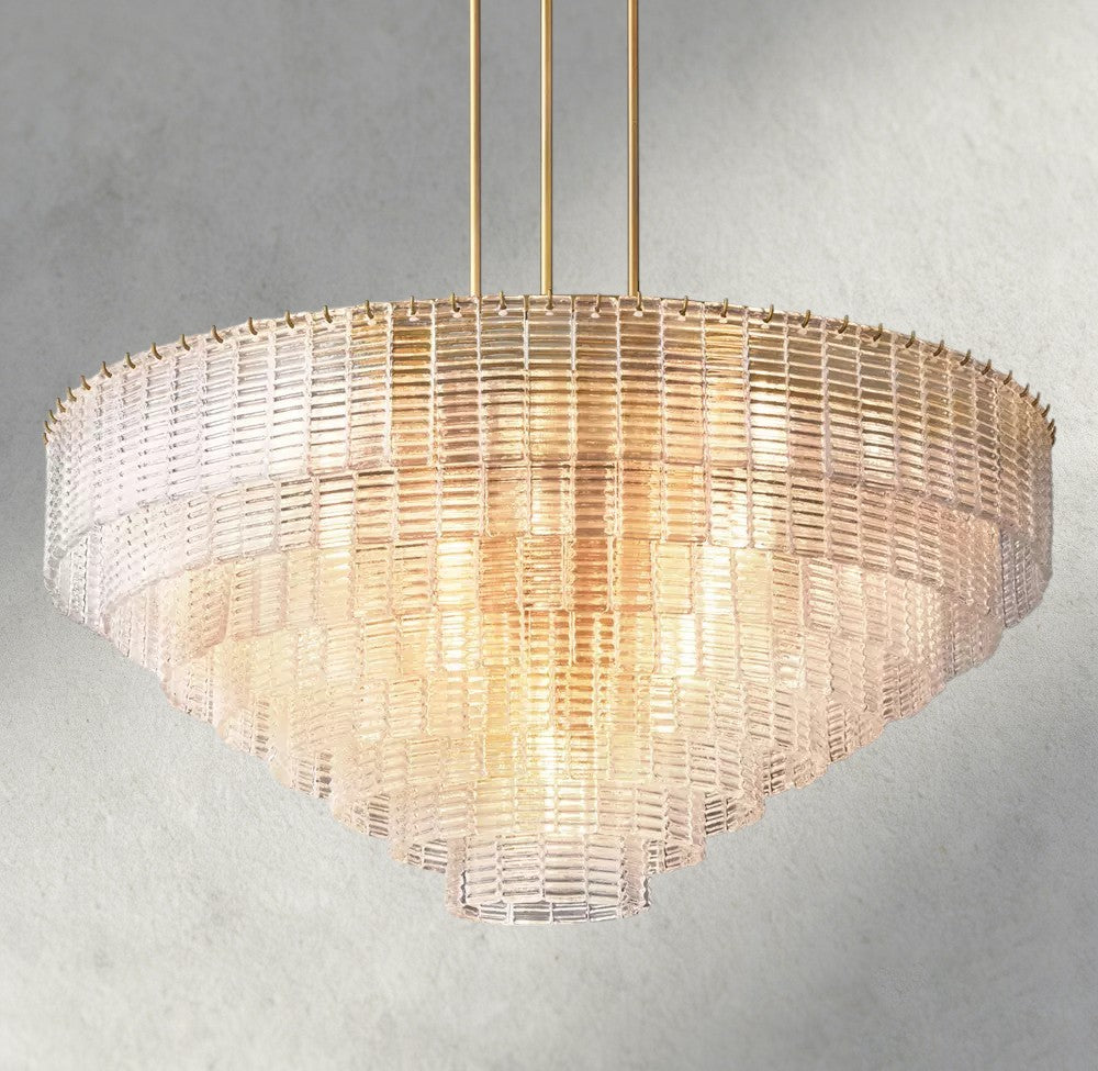 Lampthe Sirene clear glass round chandelier with concentric rings of textured glass and brass accents, casting warm refracted light.