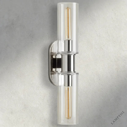 Lampthe Harlin double wall sconce with clear glass shades and polished nickel finish. Modern sophistication.