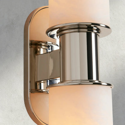 Lampthe Harlin double sconce in polished nickel with alabaster glass shades. Modern sophistication.