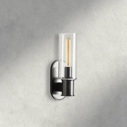 Lampthe Harlin Sconce with clear glass shade and black metal base, featuring an Edison bulb.