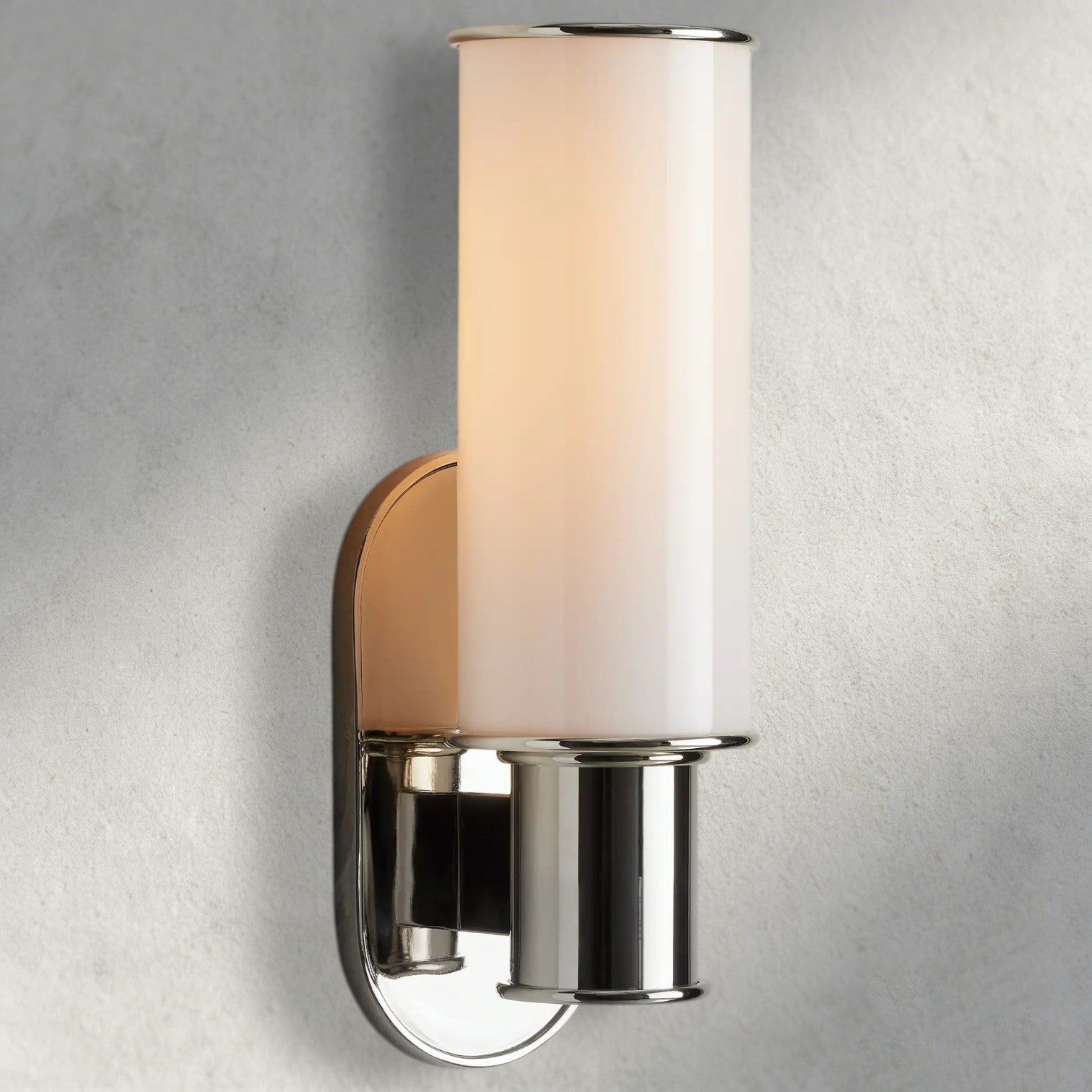 Lampthe Harlin Sconce in Milk, a modern wall light with a white frosted glass cylinder and polished nickel accents.