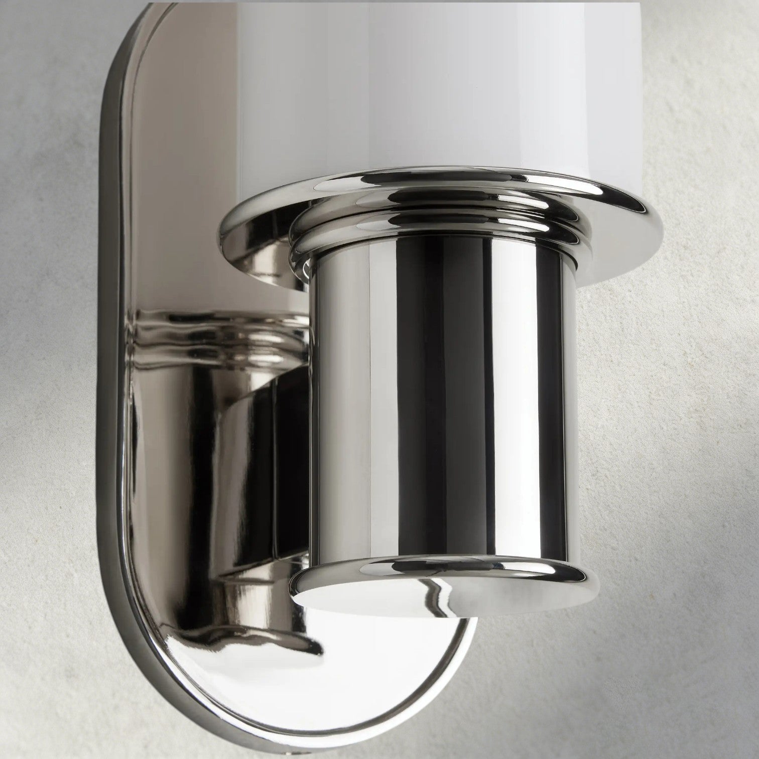Lampthe Harlin Sconce in Milk, polished nickel finish with a white glass shade. Modern sophistication.