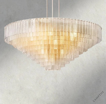 Lampthe Sirene clear glass round chandelier with textured glass cascading in concentric rings, emitting warm refracted light.